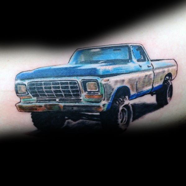 Colorful Ford pickup truck tattoo featuring a lifted vintage design with bold blue shading and rugged details for a classic off-road look.