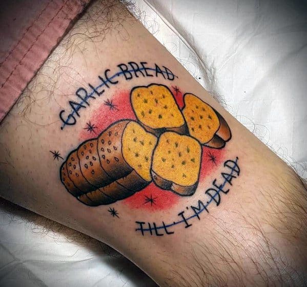 Colorful tattoo of garlic bread slices with a red glow, surrounded by the phrase "Garlic Bread Till I'm Dead," giving it a bold and humorous look.