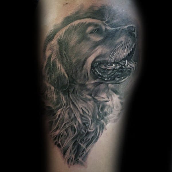 Realistic black and grey Golden Retriever tattoo, featuring detailed fur shading and lifelike expression with the dog playfully holding a ball.