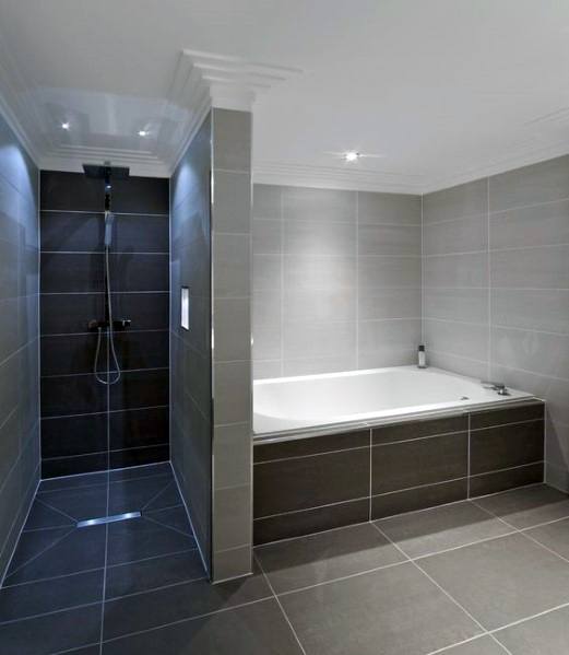 Modern bathroom with built-in bathtub, grey matte tiles, and separate shower area.