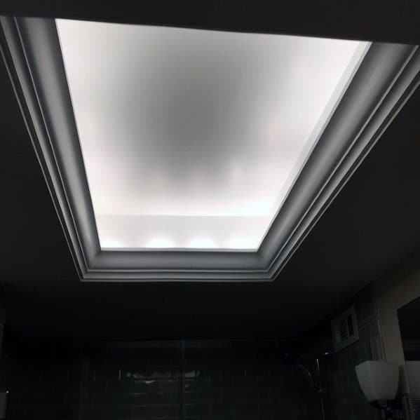 Modern bathroom with a frosted ceiling light and crown molding, enhanced by white LED lighting