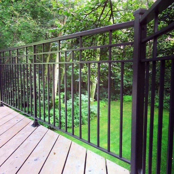 modern black metal deck railing lush garden