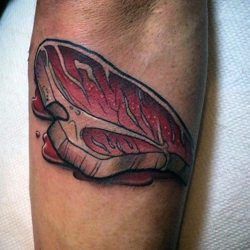 Tattoo of a raw steak with realistic marbling and shading, featuring a dripping effect for a bold and detailed meat-inspired design