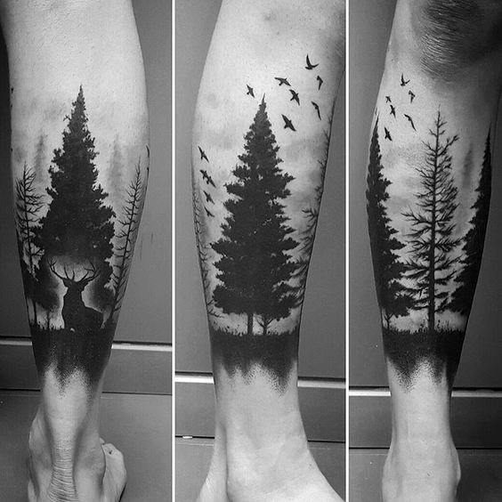 Black ink forest tattoo on the leg, featuring tall pine trees, birds in flight, and a stag silhouette for a serene and nature-inspired design.