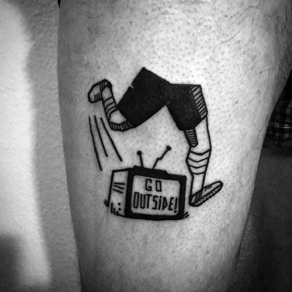 Black ink tattoo of a retro TV with "Go Outside!" on the screen, as a pair of legs in sneakers jump out, symbolizing breaking free from screens.