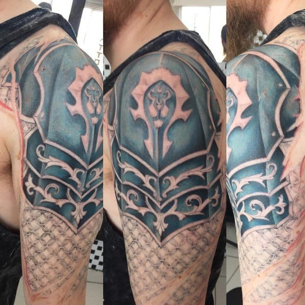 Realistic tattoo of Horde armor from World of Warcraft, featuring intricate metal plating, engravings, and the Horde emblem, inked on the upper arm.
