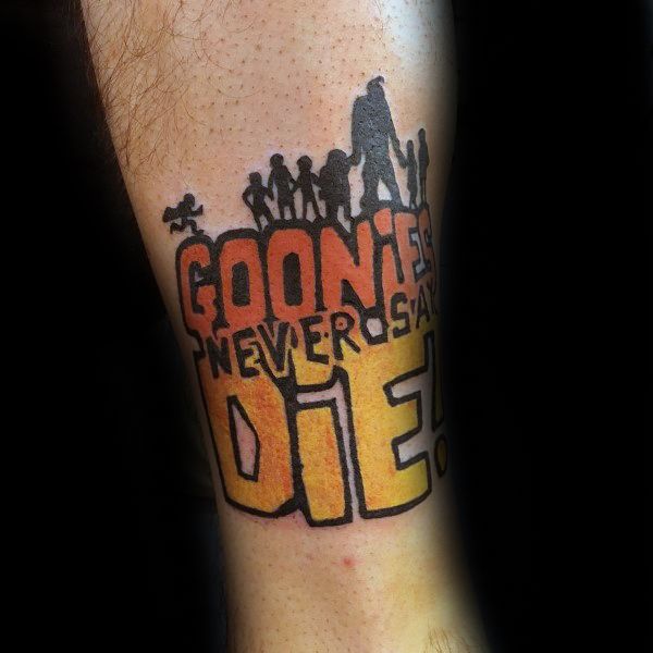 Colorful tattoo of The Goonies featuring silhouettes of the characters standing above bold text reading "Goonies Never Say Die!".