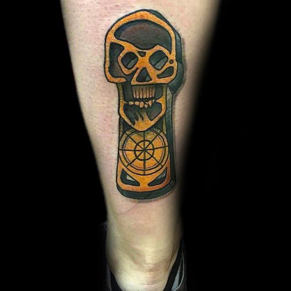 Bold traditional-style tattoo inspired by The Goonies, featuring a stylized orange skull key design with a treasure map compass detail.
