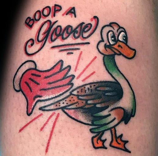 Traditional-style tattoo of a cartoon goose with a playful expression, a red hand approaching it, and the phrase "BOOP A Goose" above.
