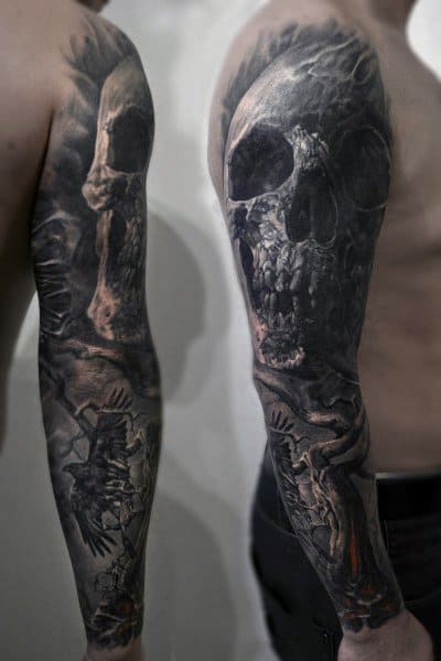 Realistic gothic sleeve tattoo featuring a large skull, skeletal hands, and dark shading for a haunting, dramatic effect.