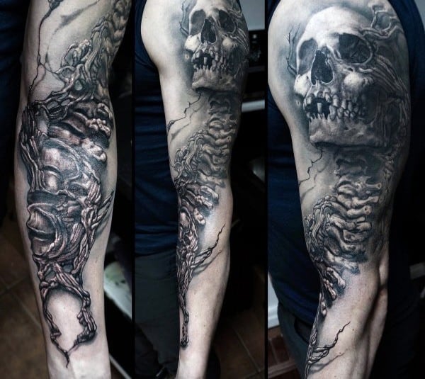 Gothic sleeve tattoo featuring a decayed skull, skeletal structures, and dark swirling details in black and grey realism for a haunting look.