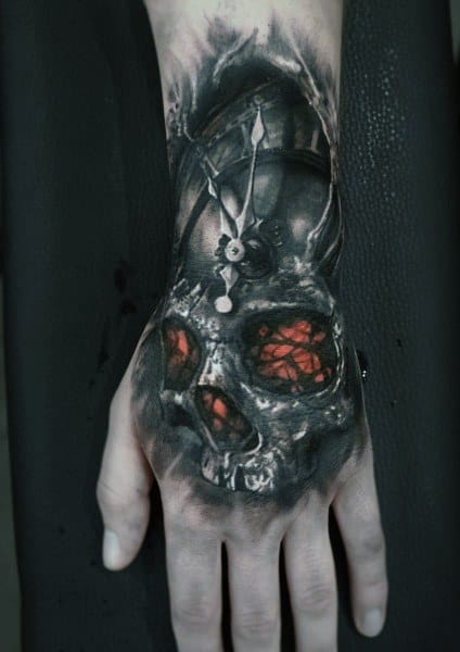 Realistic gothic hand tattoo featuring a skull with glowing red eyes and a clock, symbolizing time and mortality in a dark, eerie design.