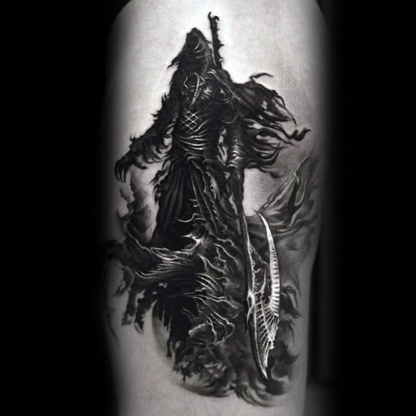 Black and grey tattoo featuring a hooded Grim Reaper with a tattered cloak, wielding a sharp scythe, surrounded by dark swirling shadows.