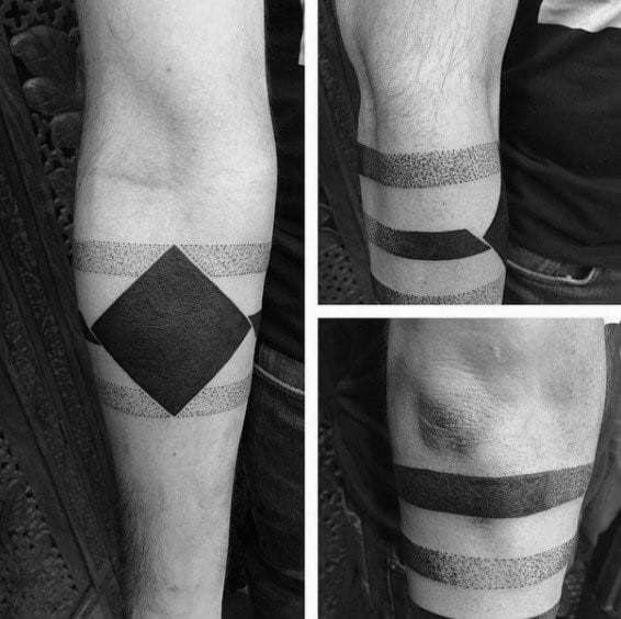 Black and grey geometric tattoo with solid bands, dotwork gradients, and a bold diamond shape wrapping around the forearm.