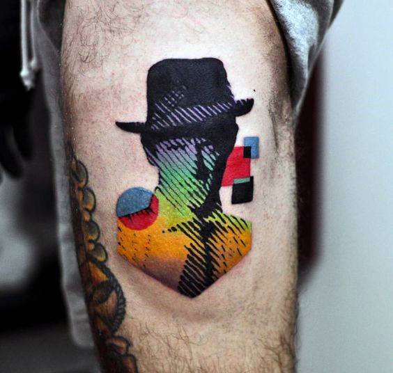 Abstract gradient tattoo of a faceless figure in a hat, filled with rainbow colors, geometric patterns, and retro-style shapes.
