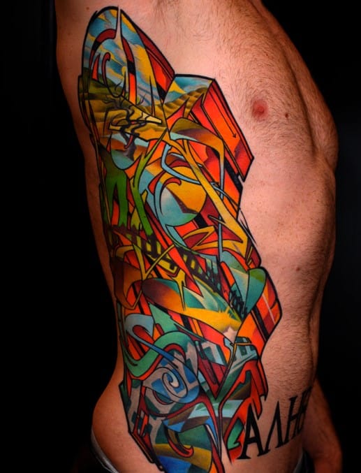 Abstract colorful tattoo covering a person's side with black text below