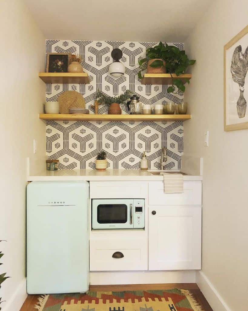 small white kitchen cabinets pale blue fridge and mircrowave title pattern wall wood shelves