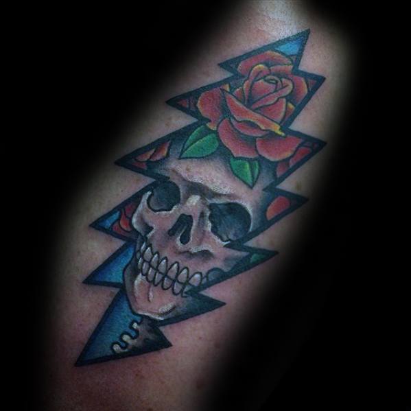 Grateful Dead lightning bolt tattoo with a skull and red rose inside, blending dark shading with bold blue and red tones.