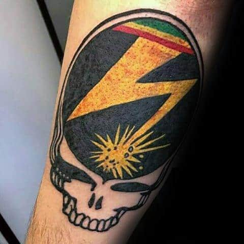 Grateful Dead Steal Your Face skull tattoo with a bold yellow lightning bolt and Rasta color accents in a textured retro style.