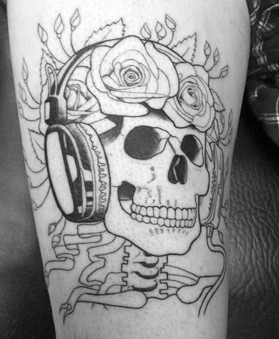 Grateful Dead inspired skull tattoo with roses on the head and large headphones, drawn in bold black linework style.
