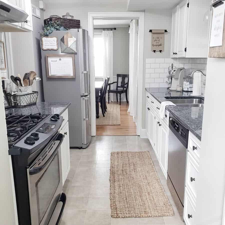 gray modern galley kitchen white cabinets subway title splashback