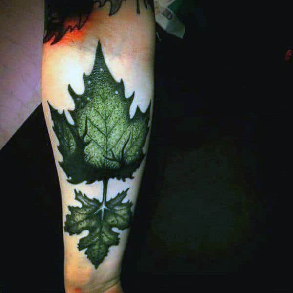 Green Mens Leaf Tattoo With Deer In Background On Arm