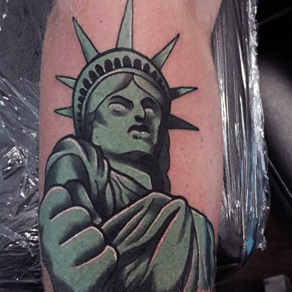 Green Statue Of Liberty Clenching Fish Mens Tattoo