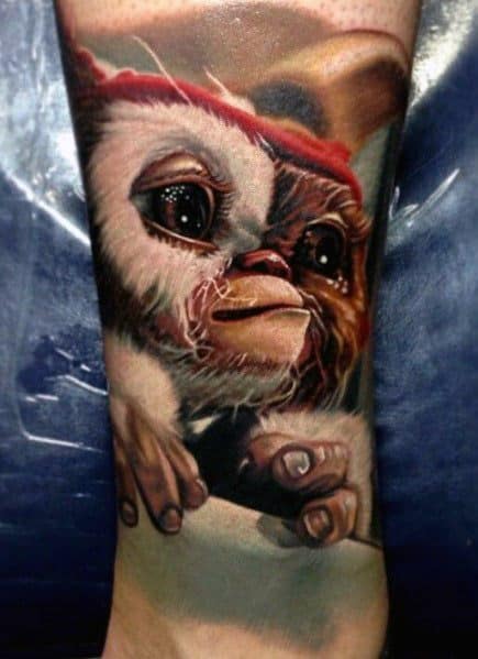 Realistic Gizmo tattoo with lifelike fur, glossy eyes, and a soft expression, capturing the adorable essence of the beloved Mogwai.