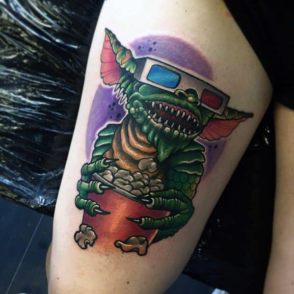 Gremlin tattoo with 3D glasses, sharp teeth, and a bucket of popcorn, capturing a fun and mischievous movie-night vibe.