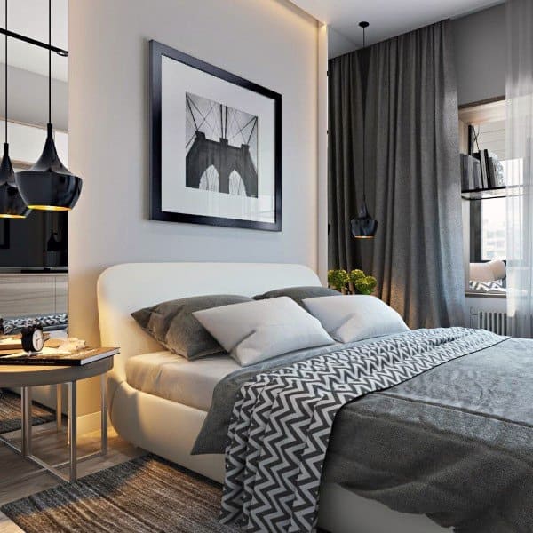 Contemporary bedroom with framed wall art black pendant lights and gray bedding.