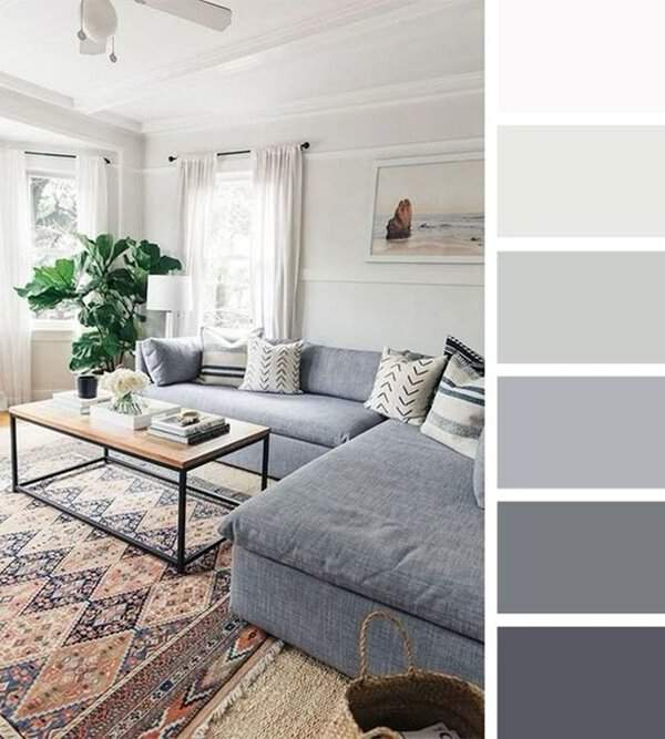 Grey and white living room with a cozy sectional, patterned rug, and natural light.