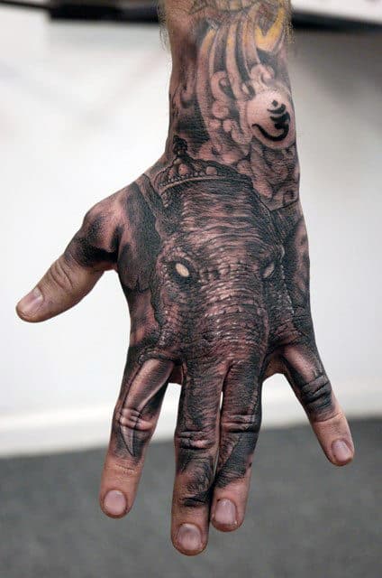Grey Elephant Head And OM Tattoo Male Hands