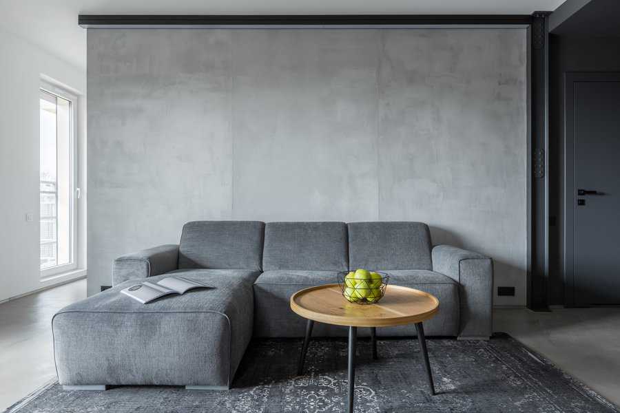 grey sofa minimalist living room concrete wall