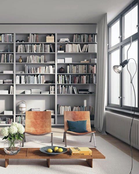 Modern room with a bookshelf, two chairs, side table, and large window