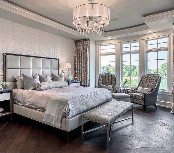 white tile accent wall gray master bedroom with hardwood floors 