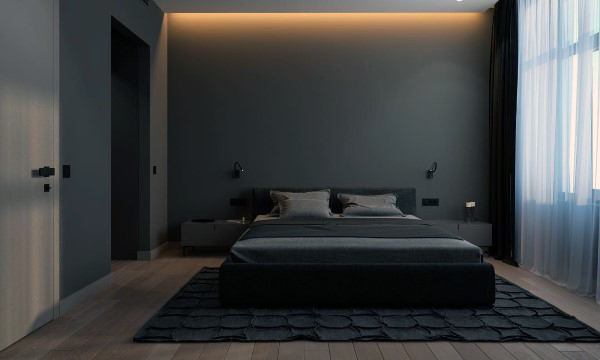 Minimalist bedroom with dark walls, a bed with grey bedding, and soft lighting from the ceiling and window