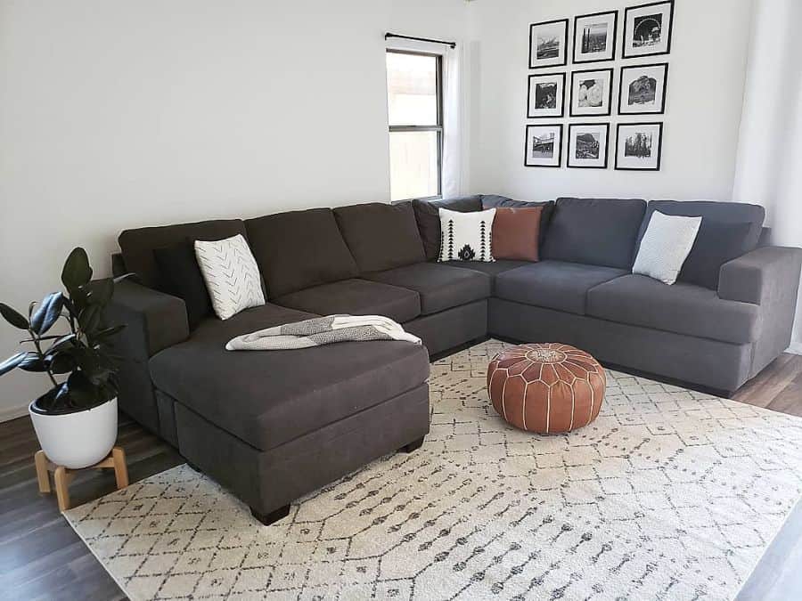 gray sectional sofa framed photo wall art pattern floor rug