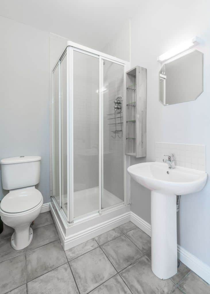 gray slate tile floor in white bathroom 