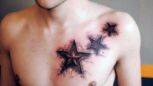 Man with star tattoos on his upper chest and shoulder