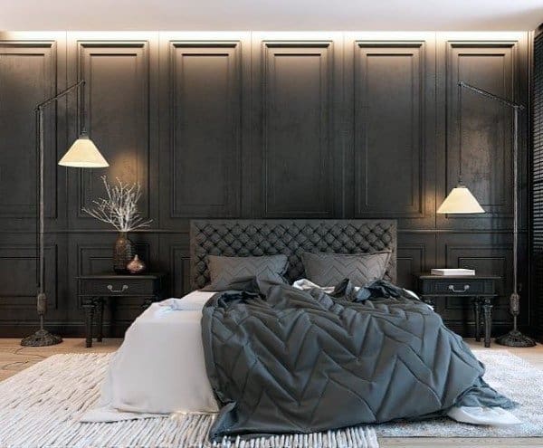 Elegant black bedroom with tufted headboard, paneled walls, and sleek adjustable lighting.