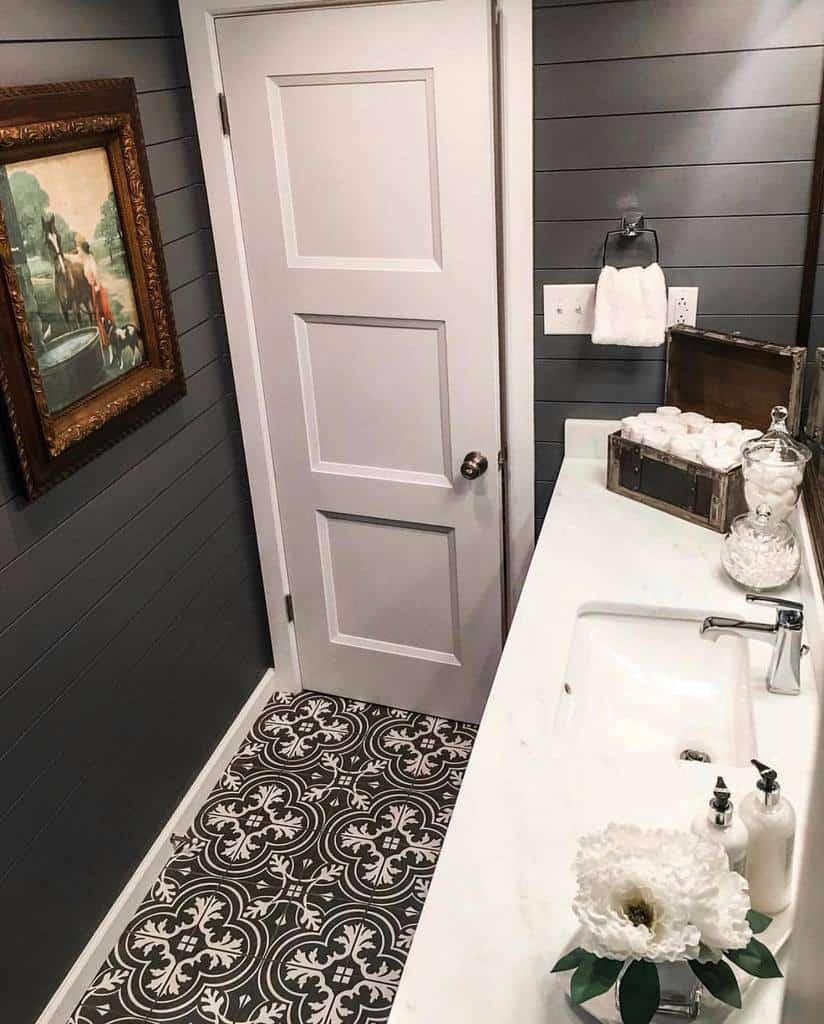small bathroom gray shiplap walls white vanity black and white floor pattern tile design