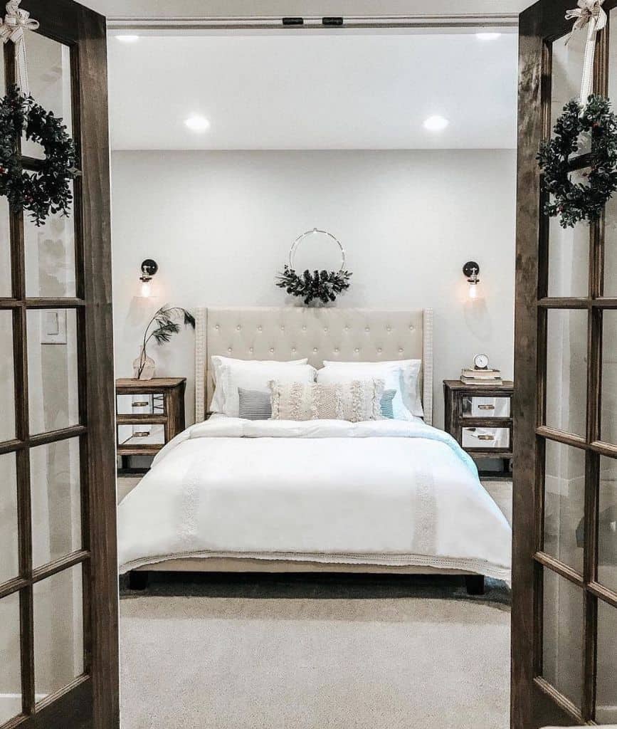 Cozy rustic guest bedroom with neutral decor, tufted headboard, and wooden bedside tables.