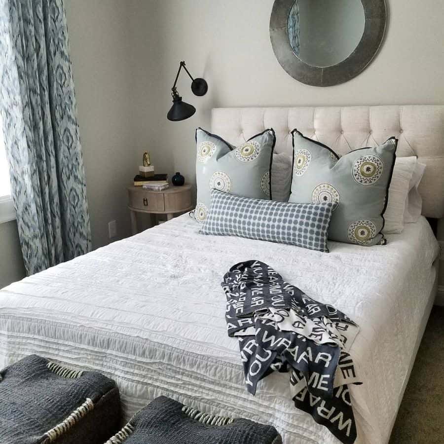 Elegant guest bedroom with tufted headboard, patterned pillows, and cozy decor accents.