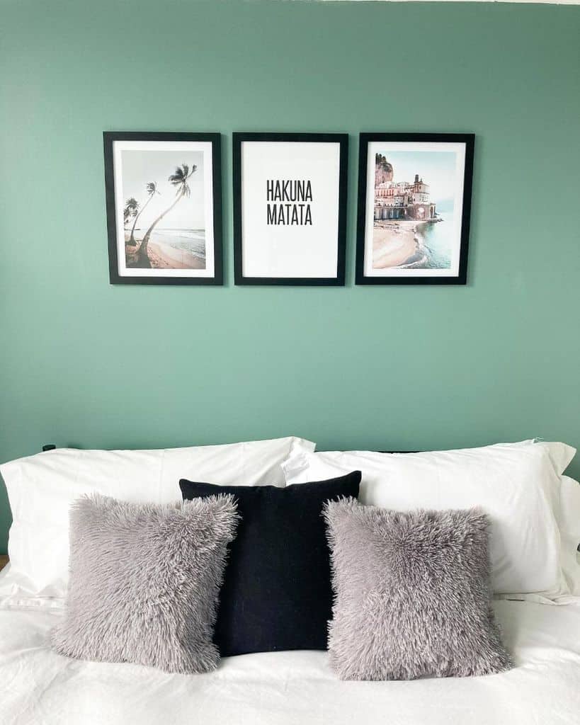 green wall bedroom framed travel photos on the wall