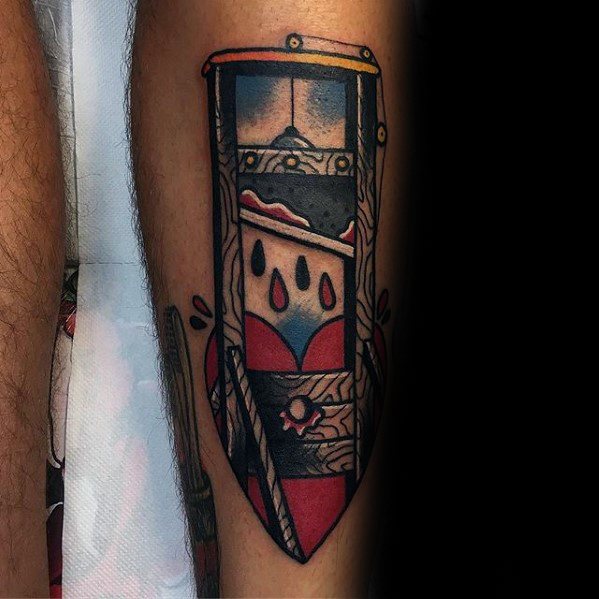 Neo-traditional guillotine tattoo with a heart at the base, dripping black droplets, and bold shading in red, blue, and black tones.