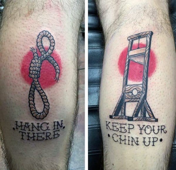 Matching tattoos featuring a noose with “HANG IN THERE” and a guillotine with “KEEP YOUR CHIN UP,” both over red circular backdrops.