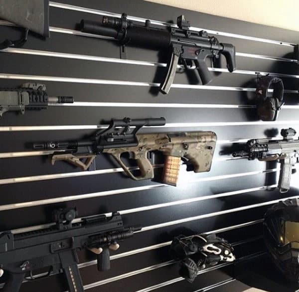 Sleek gun display with wall-mounted rifles on horizontal black slats for a modern look.