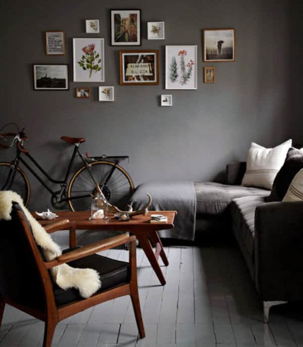 Modern living room with bicycle, gallery wall, and cozy sectional sofa.