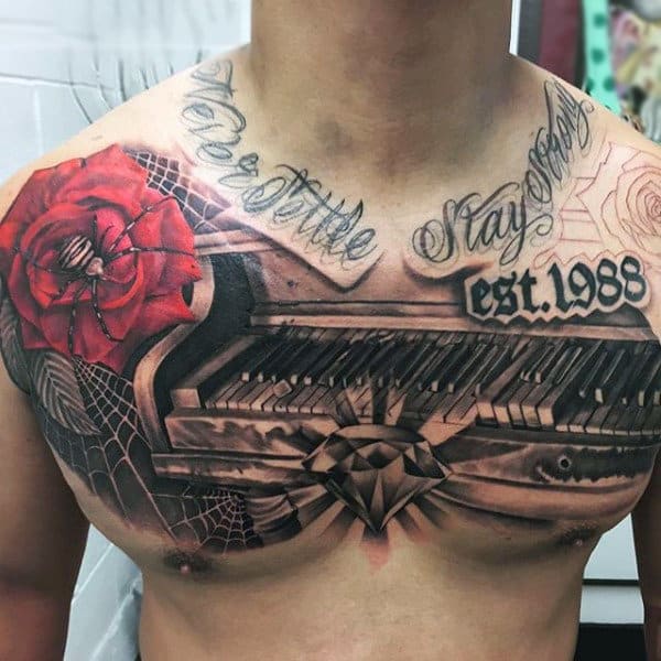 Guy Glowing Diamond On Piano And Spider Tattoo On Upper Torso