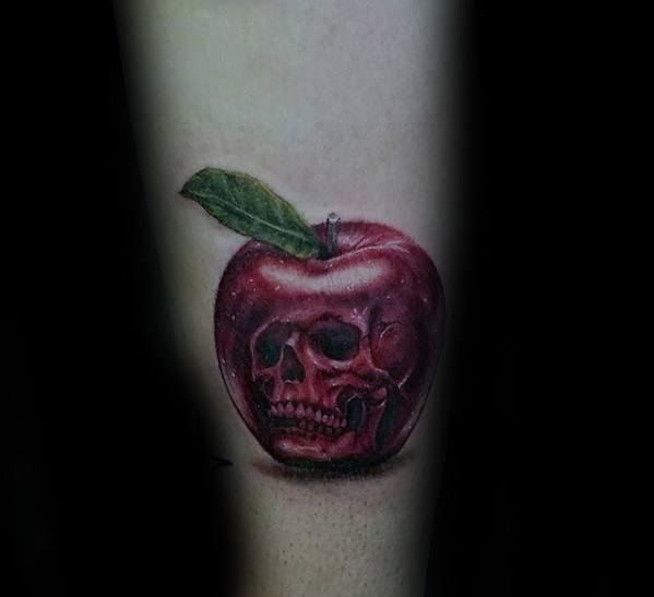 Surreal tattoo of a red apple with a human skull subtly blended into its surface, symbolizing hidden danger or temptation.